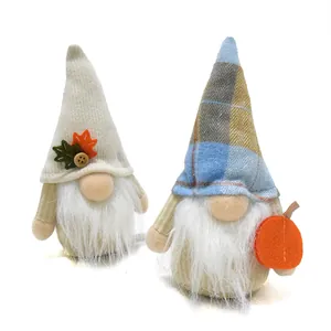Decorative pair of fall harvest gnomes with maple leaf and pumpkin for autumn home decor