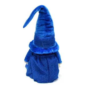 Back view of a blue wizard gnome plush toy with a tall pointed hat and glittery fabric.