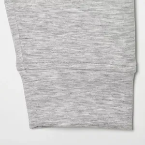 Detailed view of the soft grey heathered fabric and stitched cuff of a women's casual jacket