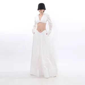 Elegant white minimalist two-piece set with long sleeve crop top and matching long skirt
