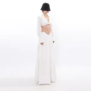 Elegant white two-piece set with a long-sleeve crop top and a flowing maxi skirt for women