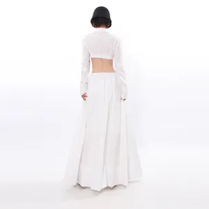 Back view of elegant white two-piece set with cropped long sleeve top and maxi skirt