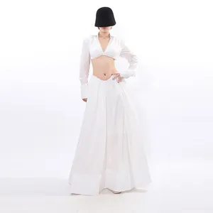 Elegant white two-piece clothing set featuring a long sleeve crop top and a maxi skirt.