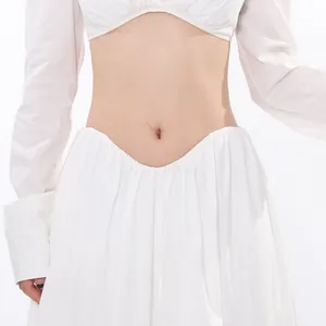 Detailed view of an elegant white long-sleeve crop top and matching long skirt set.