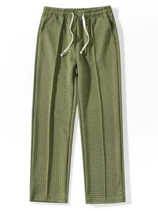 Detail view of men's olive green waffle knit casual pants with elastic drawstring waist