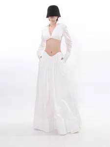 Elegant white two-piece clothing set featuring a long sleeve crop top and a flowing maxi skirt