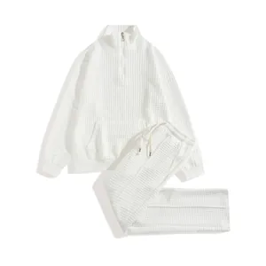 Detailed texture view of white waffle knit half-zip sweatshirt and matching sweatpants set