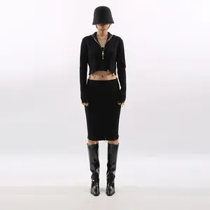 Elegant black knit two-piece set with cropped zip-up top and matching midi skirt