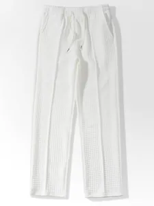 White waffle knit casual trousers with elastic drawstring waist and relaxed fit design
