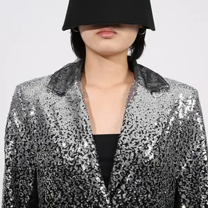 Primer plano de un elegante blazer de lentejuelas plateadas degradadas con cintura entallada