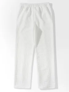 Close-up view of white waffle textured lounge pants showing material detail and relaxed fit.