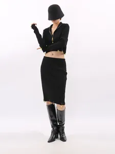 Elegant two-piece black knit set featuring cropped zip-up top and midi pencil skirt