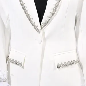 Exquisite close-up of white blazer featuring luxury rhinestone lapels and elegant feather trim