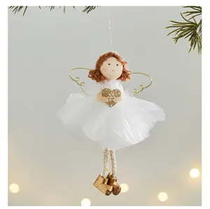 Detailed close-up of a plush angel girl ornament with white tutu and glittery heart