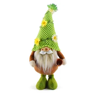 Detailed view of a green knitted gnome doll featuring a floral hat and small pot