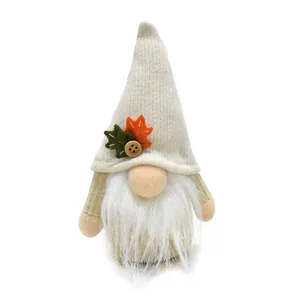Handmade plush autumn harvest gnome with decorative maple leaf and button detail