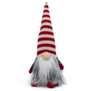 Close-up of a Christmas gnome doll with a red and white striped knitted hat and white beard