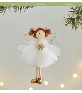 Beautiful white Christmas angel girl ornament hanging on a tree with golden wings