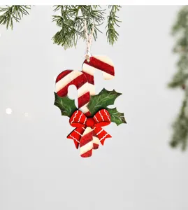 Detailed view of candy cane wooden Christmas tree ornament with holly leaves