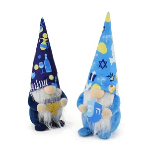 Two plush Hanukkah gnomes with festive blue hats holding a menorah and dreidel