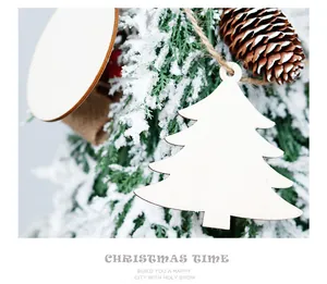 Close-up of a blank wooden Christmas tree ornament hanging on a snow-covered pine branch