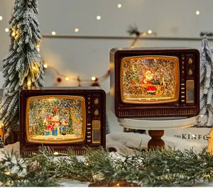 Detailed view of two retro Christmas TV snow globes with swirling glitter and warm lights