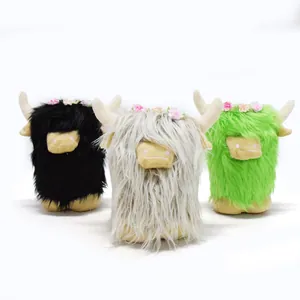 Trio of cute Scottish highland cow plush toys in black, grey, and green with flower crowns