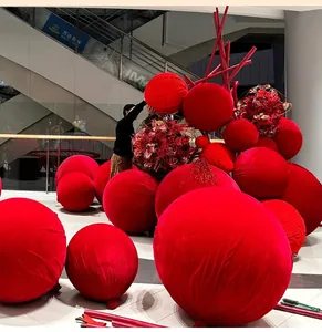 Detailed view of large burgundy velvet decorative balls for festive mall scene layout