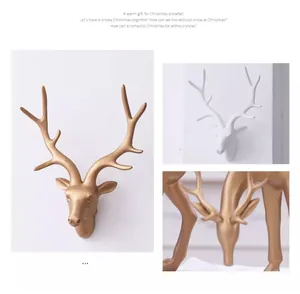Detailed view of gold and white resin deer head wall ornaments for Christmas decoration