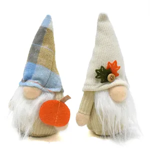 Pair of handcrafted autumn gnomes with maple leaf and pumpkin details for fall decor