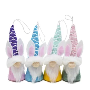 Detail view of four Easter gnome hanging ornaments with bunny ears and knit hats