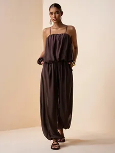 Elegant deep brown pleated satin jumpsuit set featuring spaghetti straps and wide-leg trousers.