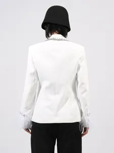 Elegant white tailored blazer featuring feather-trimmed cuffs and chic crystal accents.