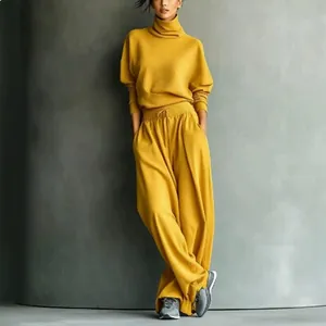 Fashionable mustard yellow turtleneck sweatshirt and wide-leg trousers two-piece lounge set.