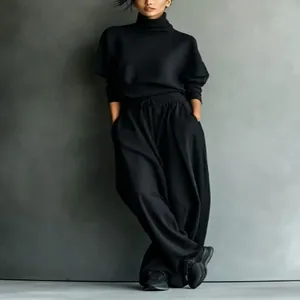 A stylish black turtleneck sweatshirt and wide-leg lounge pants two-piece set on a model