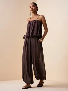 Elegant dark brown pleated satin jumpsuit with spaghetti straps and wide-leg pants.
