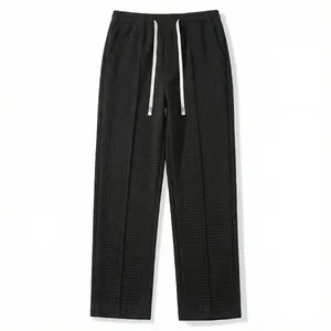 Men's casual loose waffle knit trousers in black featuring an adjustable white drawstring