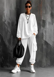 Stylish full-body view of women's white oversized two-piece set with cargo pockets