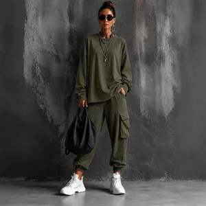 Detail view of women's olive green oversized top and cargo pants street style set