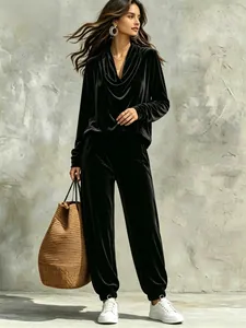 Detail view of women's black velvet lounge set featuring cowl neck and joggers.