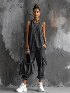 Full-body street style look of a grey sleeveless tank top and matching cargo joggers.