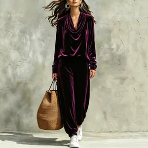 Elegant velvet two-piece lounge set with cowl neck top and jogger pants in deep purple.