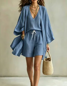 Detail showing the linen texture of a blue 3-piece set with cardigan and shorts.
