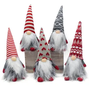 Detailed group shot of five handmade Christmas gnomes with knitted hats and white beards