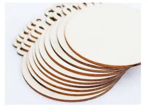 Stacked circular wooden DIY Christmas ornaments with laser-cut hanging holes.