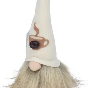 Macro detail of a plush coffee gnome featuring a decorative cup and coffee bean on its hat