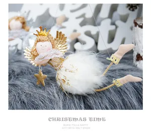 Detailed view of plush Christmas angel ornament with golden wings and crown and star