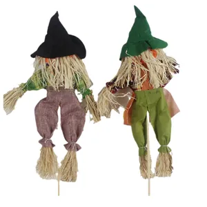 Set of two Halloween scarecrow decorations with witch hats and straw details on wooden sticks.