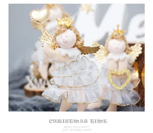 Detailed view of plush Christmas angel doll with golden wings and crown ornament.