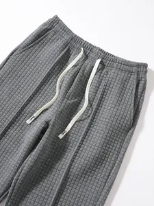 Close-up of grey waffle knit texture on men's drawstring casual pants